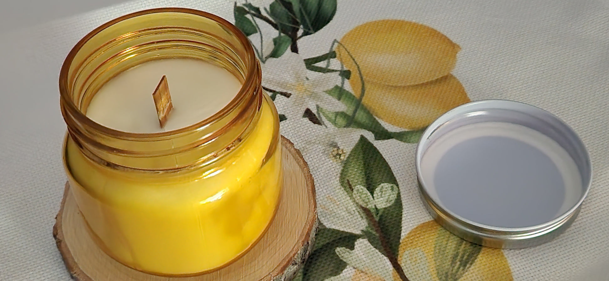 Handmade vanilla candle in yellow glass jar with lid